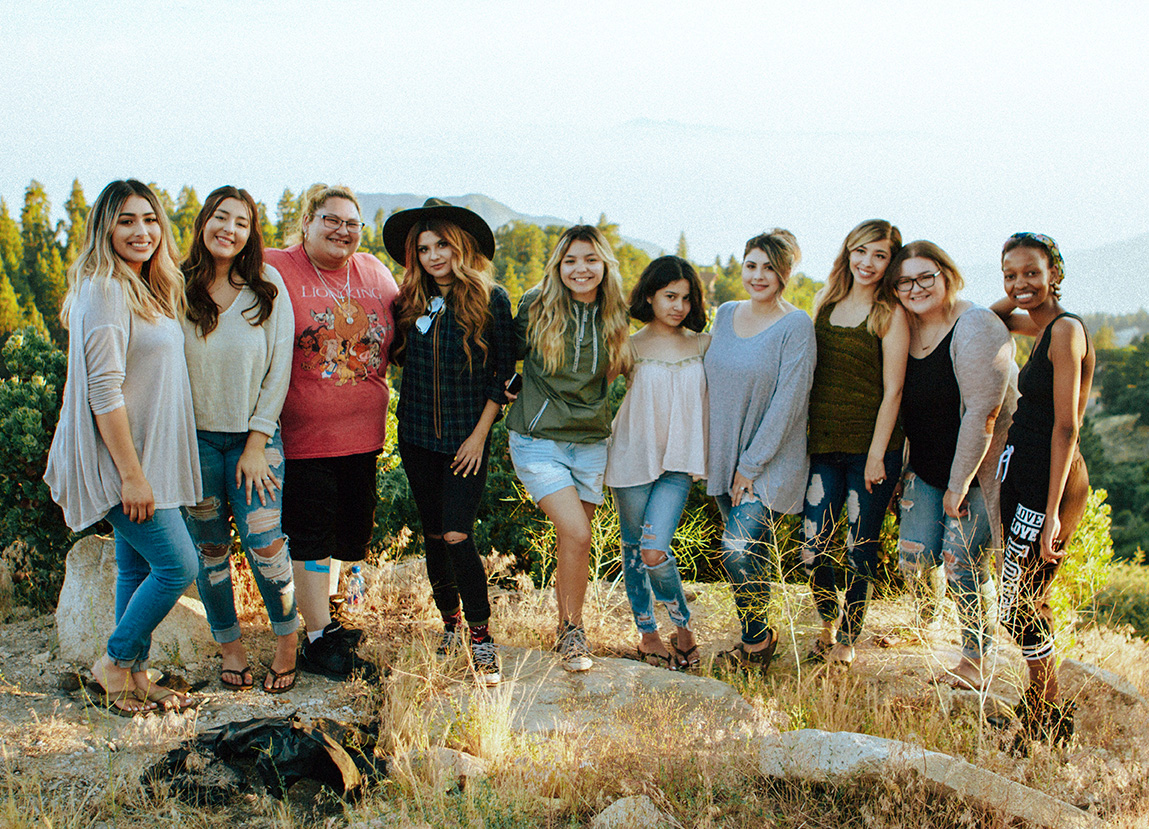 friends gathering for a photo in the mountains